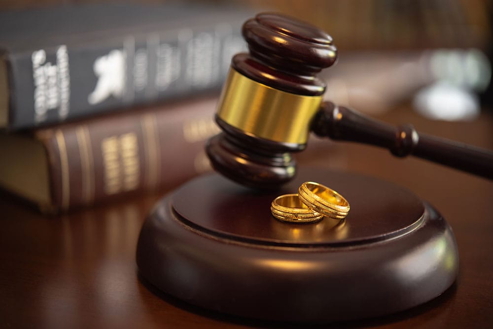 DIVORCE LAW, FAMILY LAW CONCEPTS. COURT GAVEL ,RING AND LAW BOOK AT LAWYER OFFICE. WHY CHOOSE COBB HAMMETT FOR FAMILY LAW